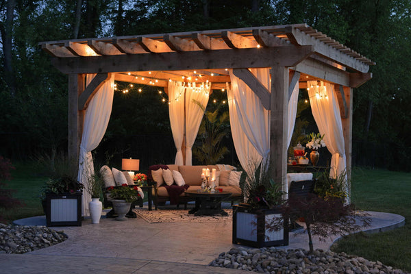 outdoor backyard seating area with string lights under wooden canopy