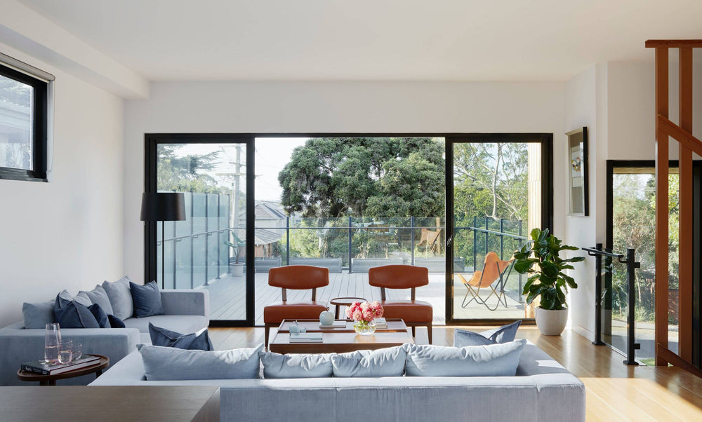 coal and cove minimalist living room outlooking backyard