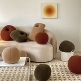 coal and cove round throw pillows in earth tones