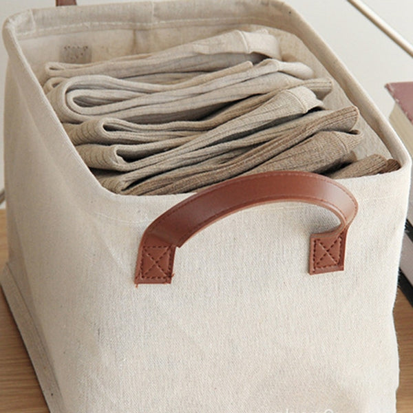 beige colored linen laundry baskets used for storing clothes and socks