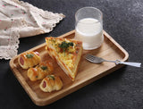 rectangle bamboo serving tray holding savoury appetizers and glass of milk