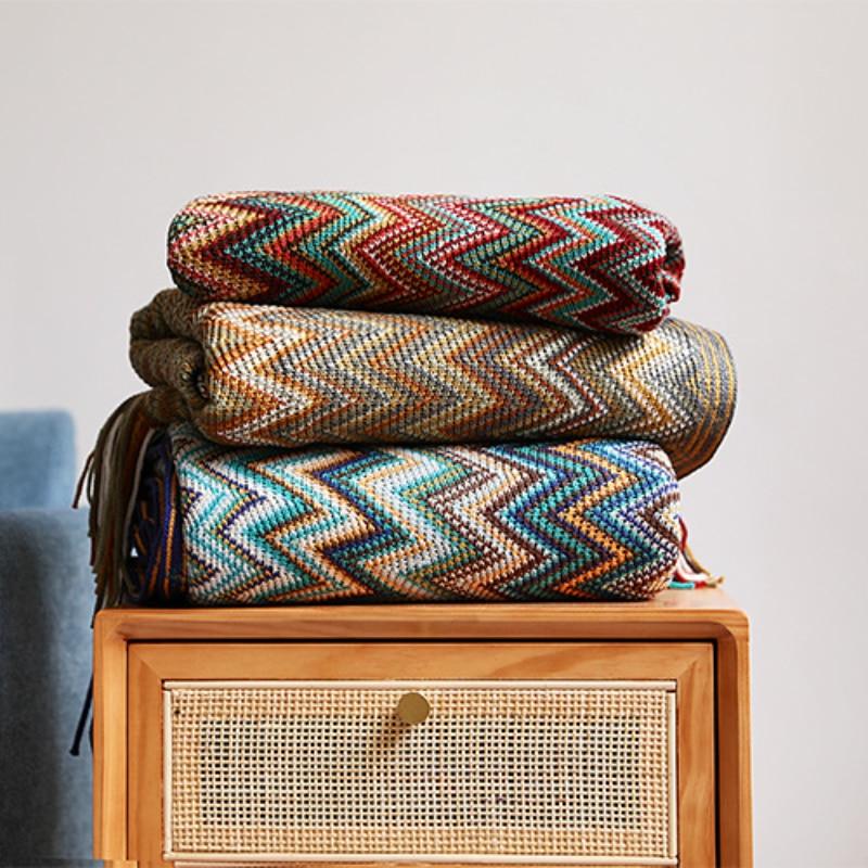 bohemian throw blanket in red, brown, and blue on table