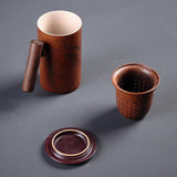 ceramic tea mug with three parts, cup, infuser, and lid