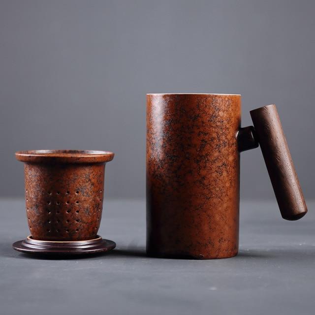 brown ceramic tea mug with infuser and lid