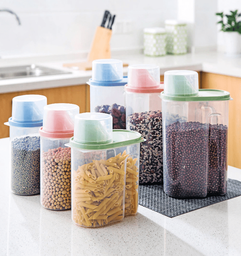 green, blue, red food storage containers for dried goods on kitchen countertop