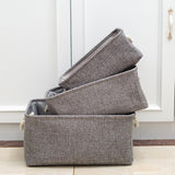 set of 3 gray cotton linen storage baskets stacked on each other