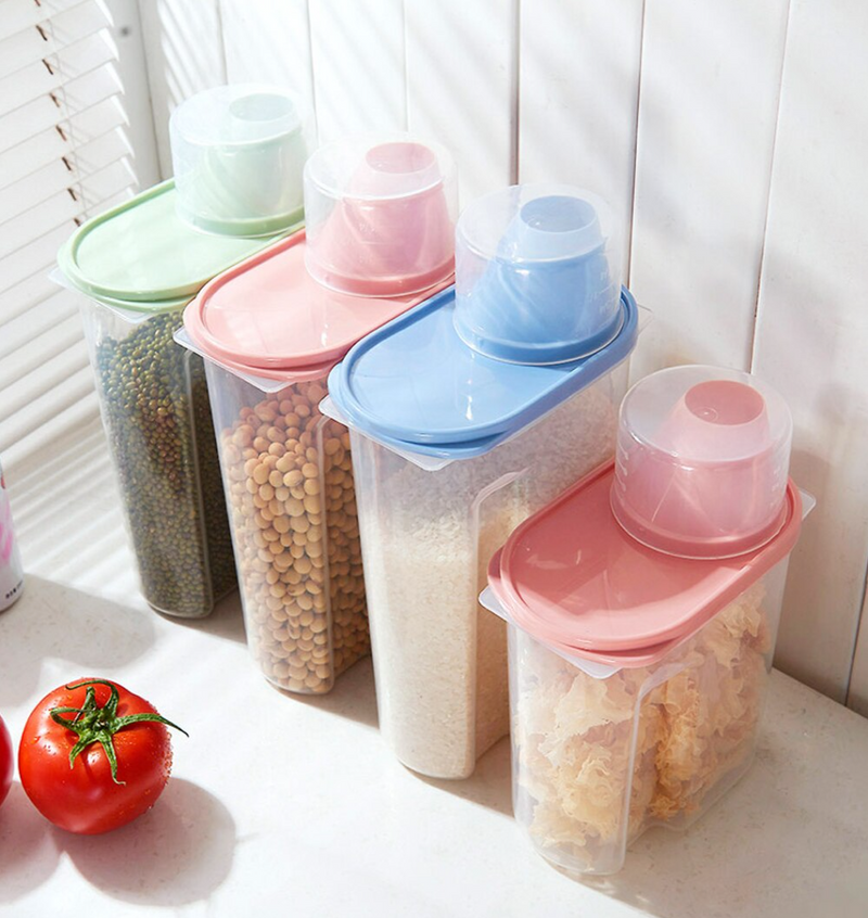 food storage containers in green, pink, blue for organizing dry goods on kitchen counter