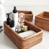 hand woven wicker basket holding soaps, lotions, perfume, and hand towel