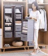 woman carrying portable hanging wardrobe organizer holding tshirts and towels