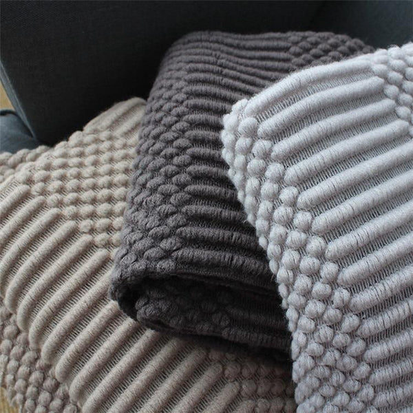 close up of knitted sofa throws that has anti-pilling patterns