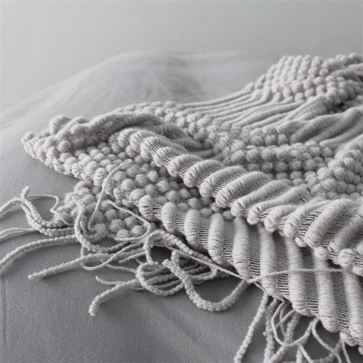 close up of knitted sofa throw on bed that can be used as bed spread
