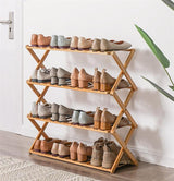 four layer foldable bamboo shoe rack by apartment door