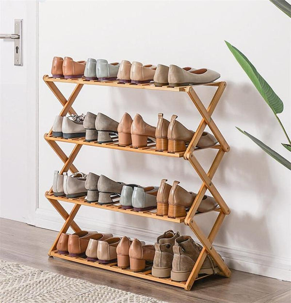 four layer foldable bamboo shoe rack by apartment door