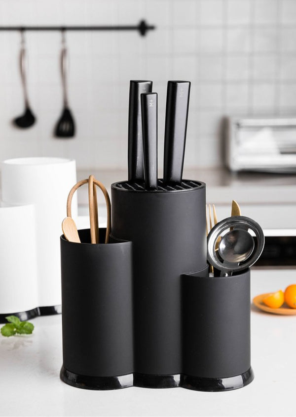 black multifunctional utensil holder organizing common kitchen tools and utensils on countertop