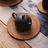 rattan coaster protecting table from hot tea pot
