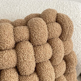 close up of plush material on knotted plush cushion