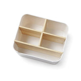 top view of white table organizer with five wooden compartments