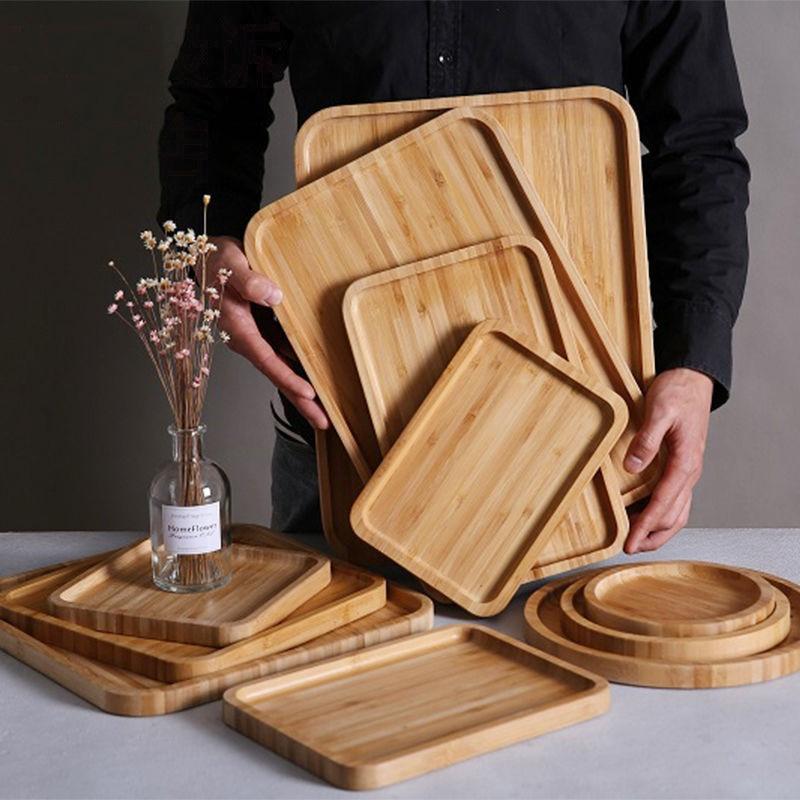 full set of wooden bamboo serving trays in round, rectangle, and square shapes