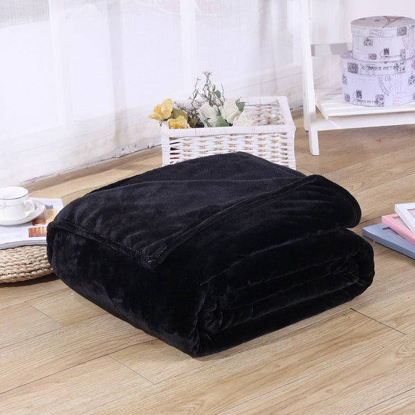 comfy black coral fleece blanket folded up on bedroom floor