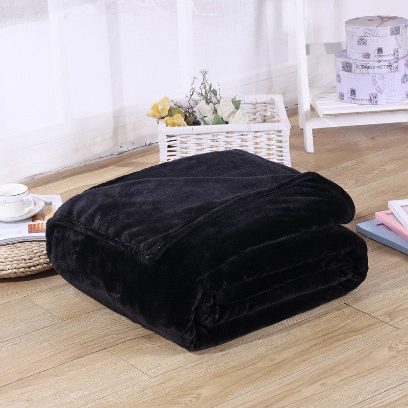 comfy black coral fleece blanket folded up on bedroom floor